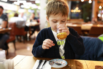 Child drinking tea from turkish glass