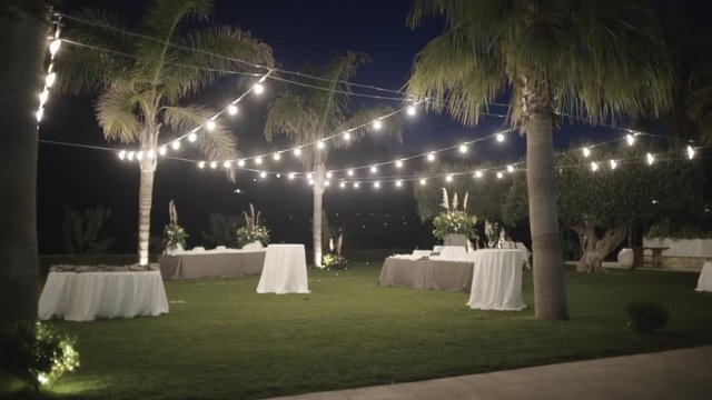Decorated Park for weddings. Action. Beautifully decorated wedding ceremony location under a large trees