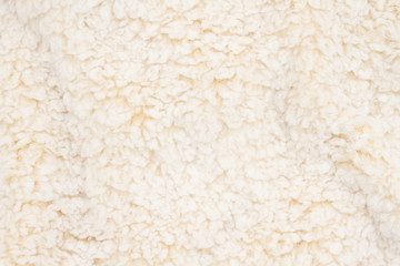 Beige sherpa textured plush fabric material background
