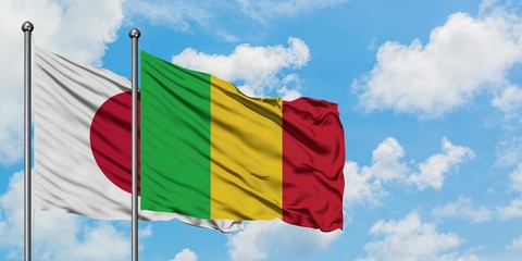 Japan and Mali flag waving in the wind against white cloudy blue sky together. Diplomacy concept,...