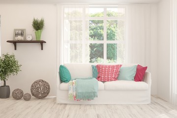 Stylish room in white color with sofa and summer landscape in window. Scandinavian interior design. 3D illustration