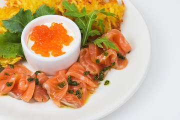 Plate with potato pancakes salmon fish and red caviar