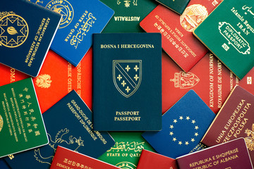 Bosnia and Herzegovina passport on the background of multi-colored passports of many countries of...