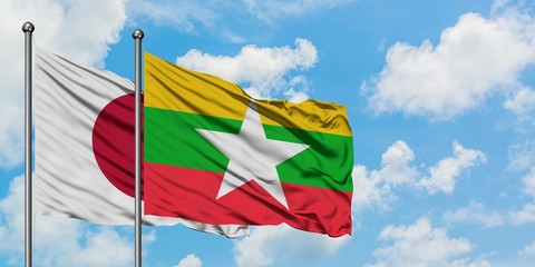 Japan and Myanmar flag waving in the wind against white cloudy blue sky together. Diplomacy concept, international relations.