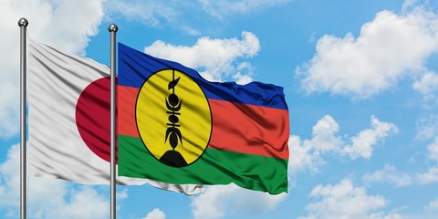 Japan and New Caledonia flag waving in the wind against white cloudy blue sky together. Diplomacy concept, international relations.