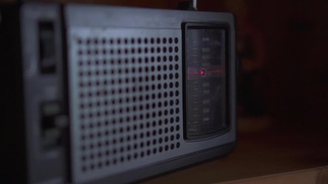 Close-up of vintage radio on wooden shelf, selective focus