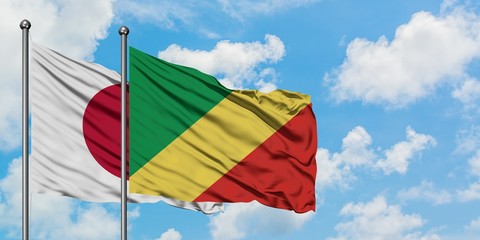 Japan and Republic Of The Congo flag waving in the wind against white cloudy blue sky together. Diplomacy concept, international relations.