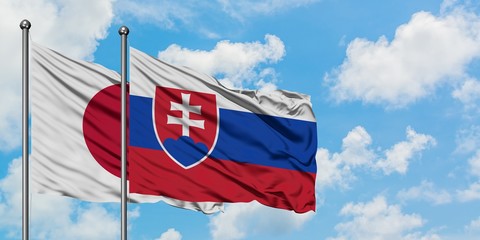 Japan and Slovakia flag waving in the wind against white cloudy blue sky together. Diplomacy concept, international relations.