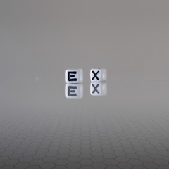 The concept of ex represented by wooden letter tiles