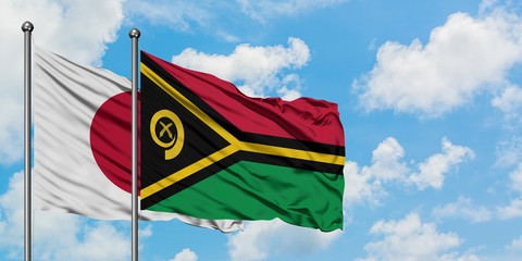 Japan and Vanuatu flag waving in the wind against white cloudy blue sky together. Diplomacy concept, international relations.