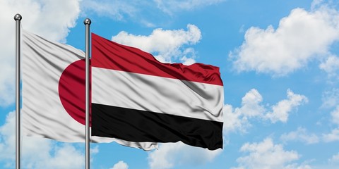Japan and Yemen flag waving in the wind against white cloudy blue sky together. Diplomacy concept, international relations.