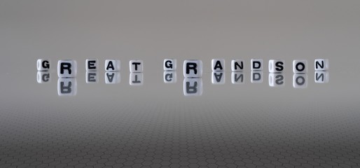 The concept of great grandson represented by black and white plastic letter cubes