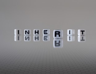 The concept of inherit represented by wooden letter tiles