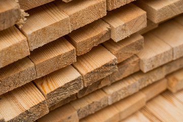 Piles of wooden boards in the sawmill, planking. Warehouse for sawing boards on a sawmill outdoors. Wood timber stack of wooden blanks construction material. Industry.