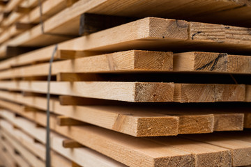 Piles of wooden boards in the sawmill, planking. Warehouse for sawing boards on a sawmill outdoors. Wood timber stack of wooden blanks construction material. Industry. - obrazy, fototapety, plakaty