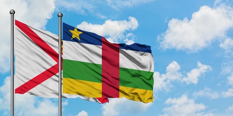 Jersey and Central African Republic flag waving in the wind against white cloudy blue sky together. Diplomacy concept, international relations.