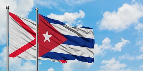 Jersey and Cuba flag waving in the wind against white cloudy blue sky together. Diplomacy concept, international relations.
