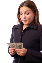 A young woman with dollars in her hands, isolated on white background