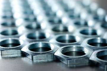 Close-up chrome metal nuts. Metal lines