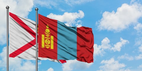 Jersey and Mongolia flag waving in the wind against white cloudy blue sky together. Diplomacy concept, international relations.