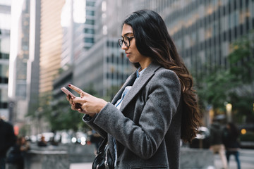 Beautiful young female using smartphone outside in New York City