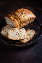 On a round wooden stand is a lean cupcake, a veggie raisin cupcake. Dark background