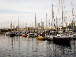 Fototapeta premium Yacht Parking in the port of Barcelona, in the background of the port management building.