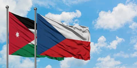 Jordan and Czech Republic flag waving in the wind against white cloudy blue sky together. Diplomacy concept, international relations.