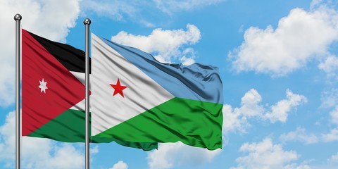 Jordan and Djibouti flag waving in the wind against white cloudy blue sky together. Diplomacy concept, international relations.