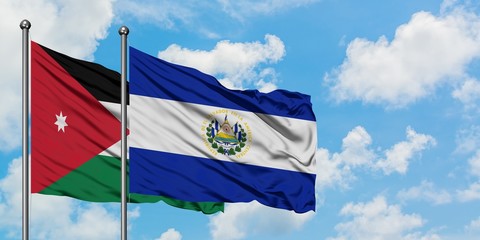 Jordan and El Salvador flag waving in the wind against white cloudy blue sky together. Diplomacy concept, international relations.