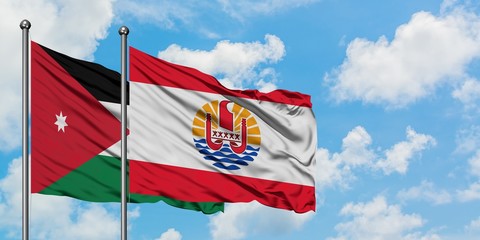 Jordan and French Polynesia flag waving in the wind against white cloudy blue sky together. Diplomacy concept, international relations.