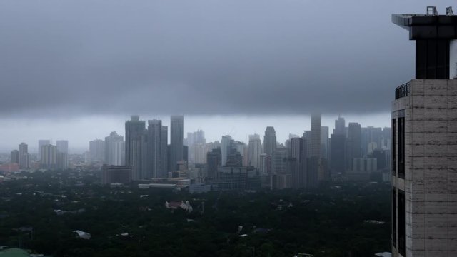 Stormy clouds passing by skyscrapers. Time lapse