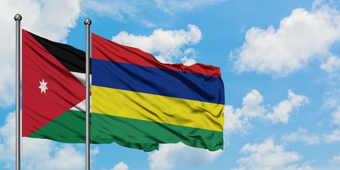 Jordan and Mauritius flag waving in the wind against white cloudy blue sky together. Diplomacy concept, international relations.