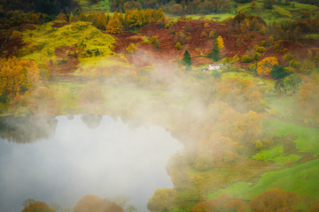 Fototapeta na wymiar Mist over Loughrigg Tarn in the English Lake District