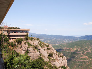 Fototapeta na wymiar View of the restaurant built on a steep cliff of Montserat mountain.
