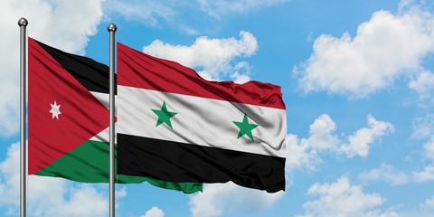 Jordan and Syria flag waving in the wind against white cloudy blue sky together. Diplomacy concept,...