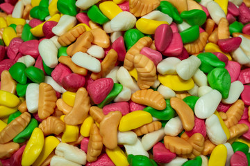 A pile of colorful marmalade candies in the form of a different fruits: strawberries, bananas, pears, oranges. Sweet candy background