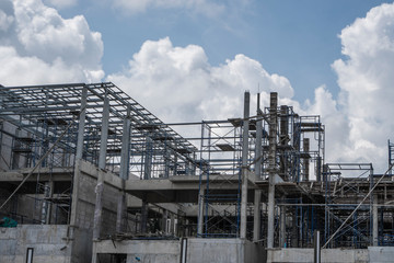 Building and Construction Site in progress. Building construction site against cloudy sky. Metal...