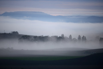 the city of Vitoria-Gasteiz, the Basque Country, dawns in the fog in one of its neighborhoods, Salburura, on the outskirts, surrounded by fields and mountains