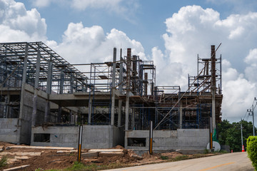 Building and Construction Site in progress. Building construction site against cloudy sky. Metal...