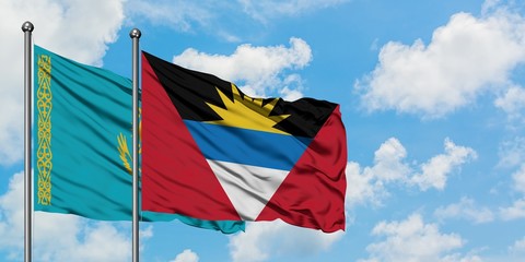 Kazakhstan and Antigua and Barbuda flag waving in the wind against white cloudy blue sky together. Diplomacy concept, international relations.