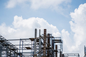 Building and Construction Site in progress. Building construction site against cloudy sky. Metal...