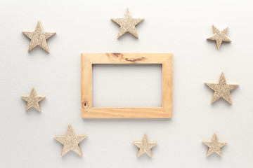 Fototapeta na wymiar Christmas composition. Wood frame stars top view background with copy space for your text. Flat lay.