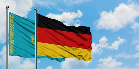 Kazakhstan and Germany flag waving in the wind against white cloudy blue sky together. Diplomacy concept, international relations.