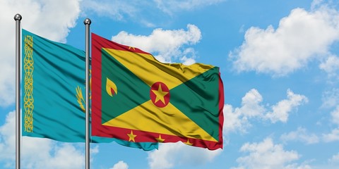 Kazakhstan and Grenada flag waving in the wind against white cloudy blue sky together. Diplomacy concept, international relations.
