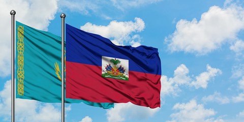 Kazakhstan and Haiti flag waving in the wind against white cloudy blue sky together. Diplomacy concept, international relations.