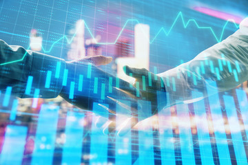 Double exposure of financial chart on cityscape background with two businessmen handshake. Concept of financial analysis and investment opportunities