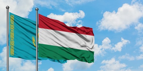 Kazakhstan and Hungary flag waving in the wind against white cloudy blue sky together. Diplomacy concept, international relations.