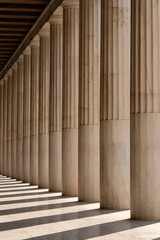 Row of ancient Greek columns in Athens. Architectural abstract.