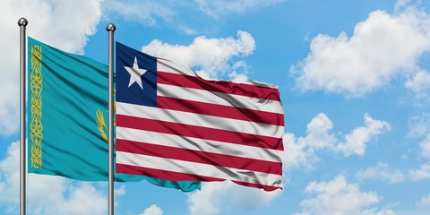 Kazakhstan and Liberia flag waving in the wind against white cloudy blue sky together. Diplomacy concept, international relations.